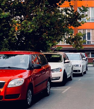 Row of Parked Cars on Urban Street near Residential Building