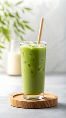 Refreshing iced matcha latte with a wooden straw on a wooden coaster perfect for a healthy beverage