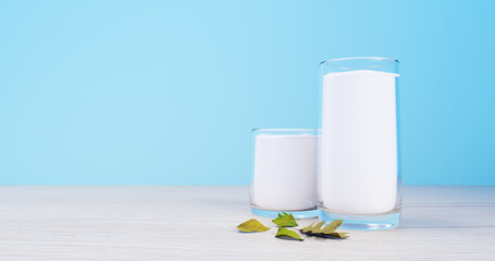 Full Glass of Fresh Milk with Mint Leaves on Wooden Surface