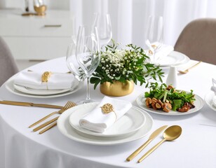 Elegant table setting with gold cutlery, white plates, and a floral centerpiece, ready for a formal dinner.