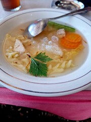 soup with macaroni, carrots, mushrooms, and meat, typically served at celebrations