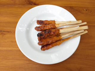 Sate lilit, sate pusut, sate kelapa, is a satay variant in Indonesia, originating from Balinese and Lomboknese cuisine.  made from fish, chicken or beef mixed with grated coconut
