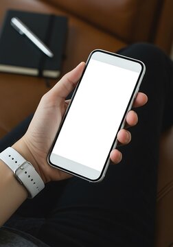 Hand holding smartphone with blank screen