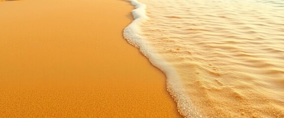 Golden sea sand texture with gentle wave patterns visible in the background,  shore,  water