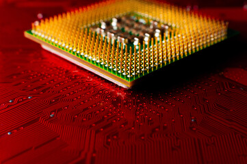 Electronic components. Electronic printed circuit board close-up, accent red color