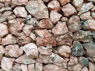 dry stone wall, a type of wall constructed without the use of mortar or cement to bind the stones together. careful selection and interlocking of stones to create a stable structure