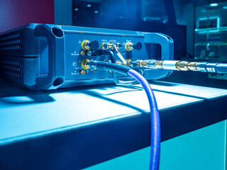 Electronic test equipment with multiple cables and RF connectors on a lab table. Electronics, telecommunications, RF testing, engineering, signal analysis, diagnostics. © Grispb