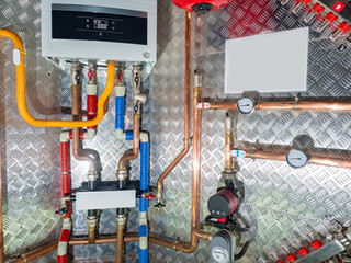 Close-up of heating system with pipes, gauges, and control unit. Plumbing, HVAC, home heating,...