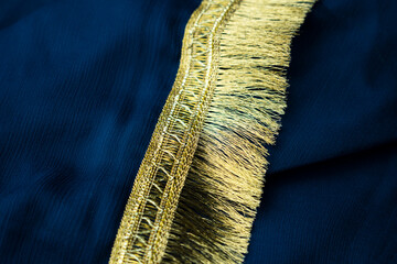 Luxurious Gold Trim on Deep Blue Fabric: Elegant Texture and Design