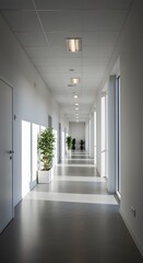 Obraz premium A long, bright hallway with white walls and a plant, showcasing the interior architecture and design of a modern office or hospital building