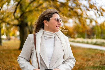 Portrait of beautiful mature woman in autumn scenery