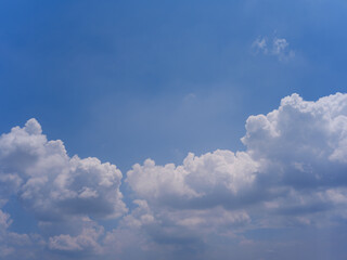 White Fluffy Cumulus Clouds in Clear Blue Summer Sky