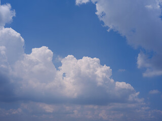 White Fluffy Cumulus Clouds in Clear Blue Summer Sky