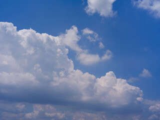 White Fluffy Cumulus Clouds in Clear Blue Summer Sky