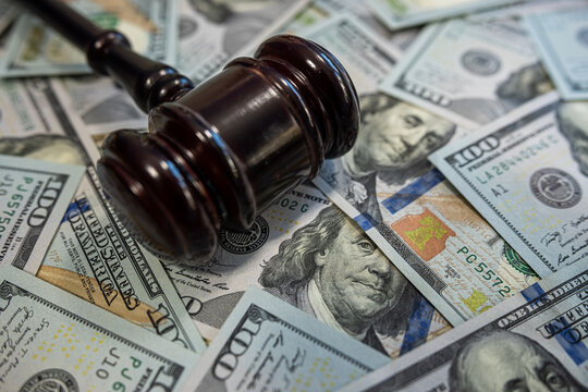 Gavel on hundred dollar bills &ndash; Law and money, justice system, legal fees or corruption concept