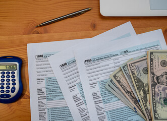 1040 Tax Form with Calculator, Cash and Pen – US Financial Report and Income Planning