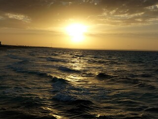 Twilight waves dancing under golden skies