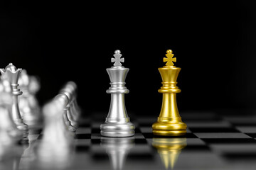 Gold and silver chess kings face to face. A concept of business competition, strategy, negotiation,...