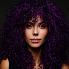 Fototapeta premium Young female model with striking purple curly hairstyle looking confidently at camera in professional studio lighting, trendy beauty portrait for fashion and hair styling commercials
