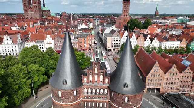 Flying through the twin towers of the Holstentor the gate of L&uuml;beck, Germany with the red-brick Gothic architecture.