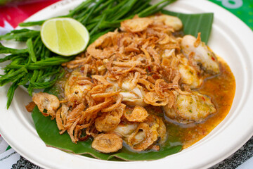 Thai Oyster spicy salad with lemon in paper plate