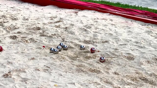 Game Bocce petanque bowl sport metal balls in the sand .throwing steel balls balls into the sand accuracy