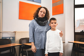 Female teacher with elementary student at language school class