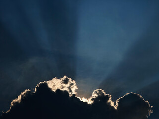 Dramatic sun rays coming from the clouds