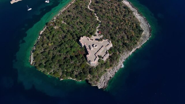 Aerial view of porto palermo castle, a star-shaped fortress nestled on a small peninsula in the ionian sea, near himar&euml;, albania, showcasing its unique architecture and strategic location