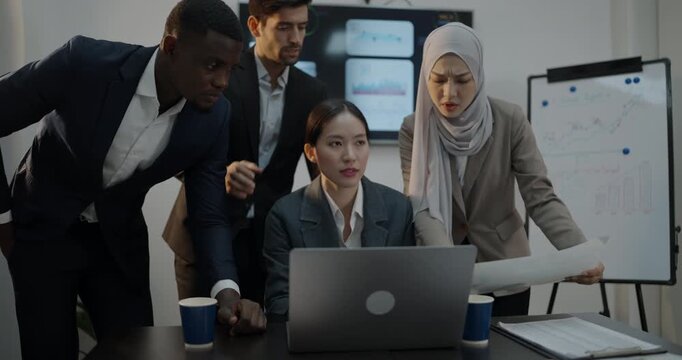 Business concept of 4k Resolution. Businessmen of different nationalities brainstorming together using computers in the office.