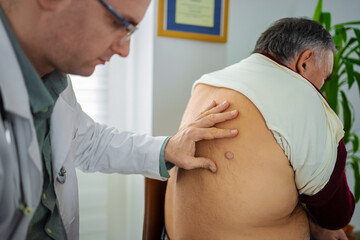 Doctor examines patient during routine medical check-up in clinic