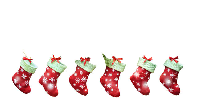 Photo of a row of six red christmas stockings with green trim and white snowflakes, isolated on a transparent background