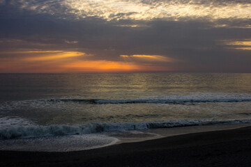 Fototapeta premium Sunset over the Irish sea, as seen from the shingles beach at Aberystwyth in Wales.