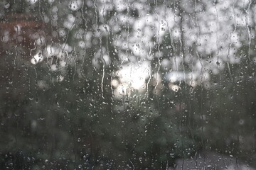 Water drops falling down window