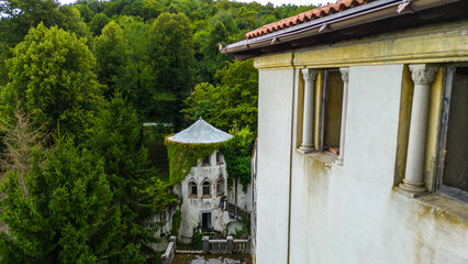 Aerial drone view of Bosiljevo Castle, a historic medieval fortress located in Karlovac County, Croatia, surrounded by dense green forest in summer
