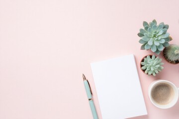 Minimalist workspace features white notepad, green pen, succulen