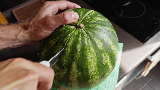 Cutting Ripe Watermelon With Knife In Kitchen. Healthy Organic Food PAnd Summer Snack