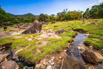Fang hot spring. A scenic view of a natural hot spring emitting steam in a lush tropical forest....