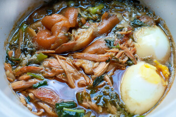 Top view of Stewed pork leg with boiled egg, focus selective