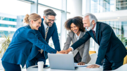 Diverse business team celebrating success, hands together over laptop in modern office, positive teamwork