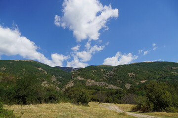 
beautiful landscape nature mountains blue sky clouds trees distance Bulgaria