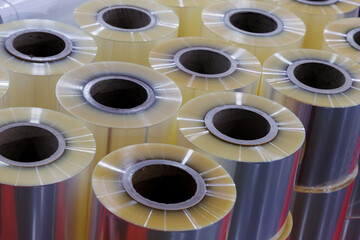 Close-up of clear food grade plastic film ready to use in packing machine for wraping industrial and consumer product packaging at food mufaturing. materials prepared for industrial use in factory