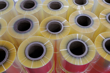 Close-up of clear food grade plastic film ready to use in packing machine for wraping industrial and consumer product packaging at food mufaturing. materials prepared for industrial use in factory