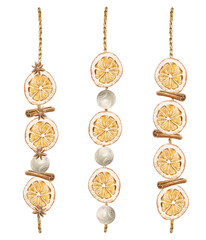 Dried orange slices, cinnamon sticks, wooden balls, anise stars hanging on a string. Christmas decor watercolor illustration isolated. Hand drawn pastel New Year clip art for creating beautiful cards.