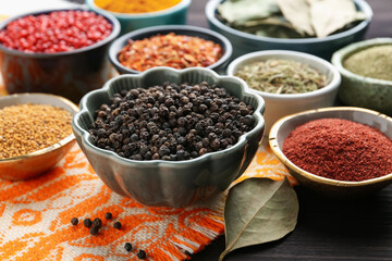 Different aromatic spices on wooden table, closeup