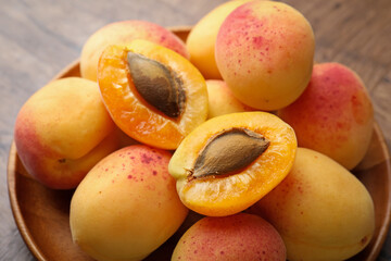 Cut and whole fresh apricots on table, closeup