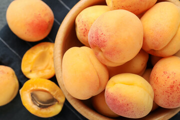 Fresh ripe apricots in bowl on table, flat lay
