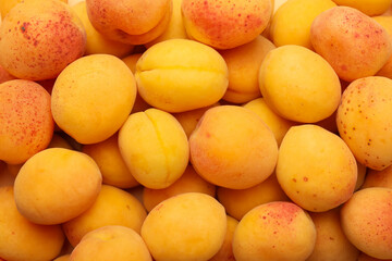 Fresh ripe sweet apricots as background, top view