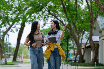 Two students walking and talking in a university campus