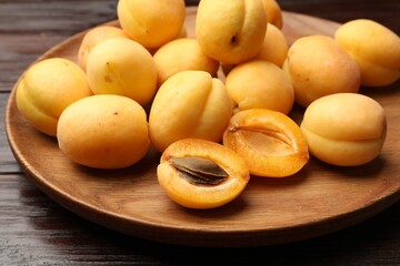 Many fresh apricots on wooden table, closeup